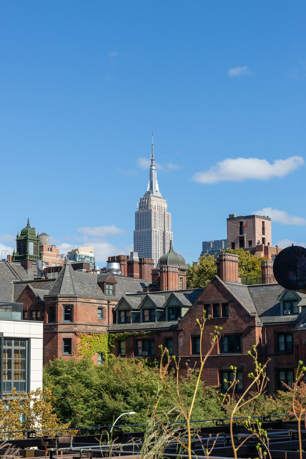 a view of a city with a tall building in the background