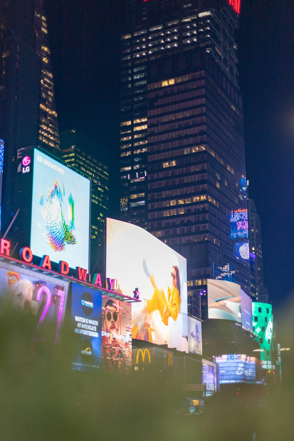 a city at night with a lot of billboards