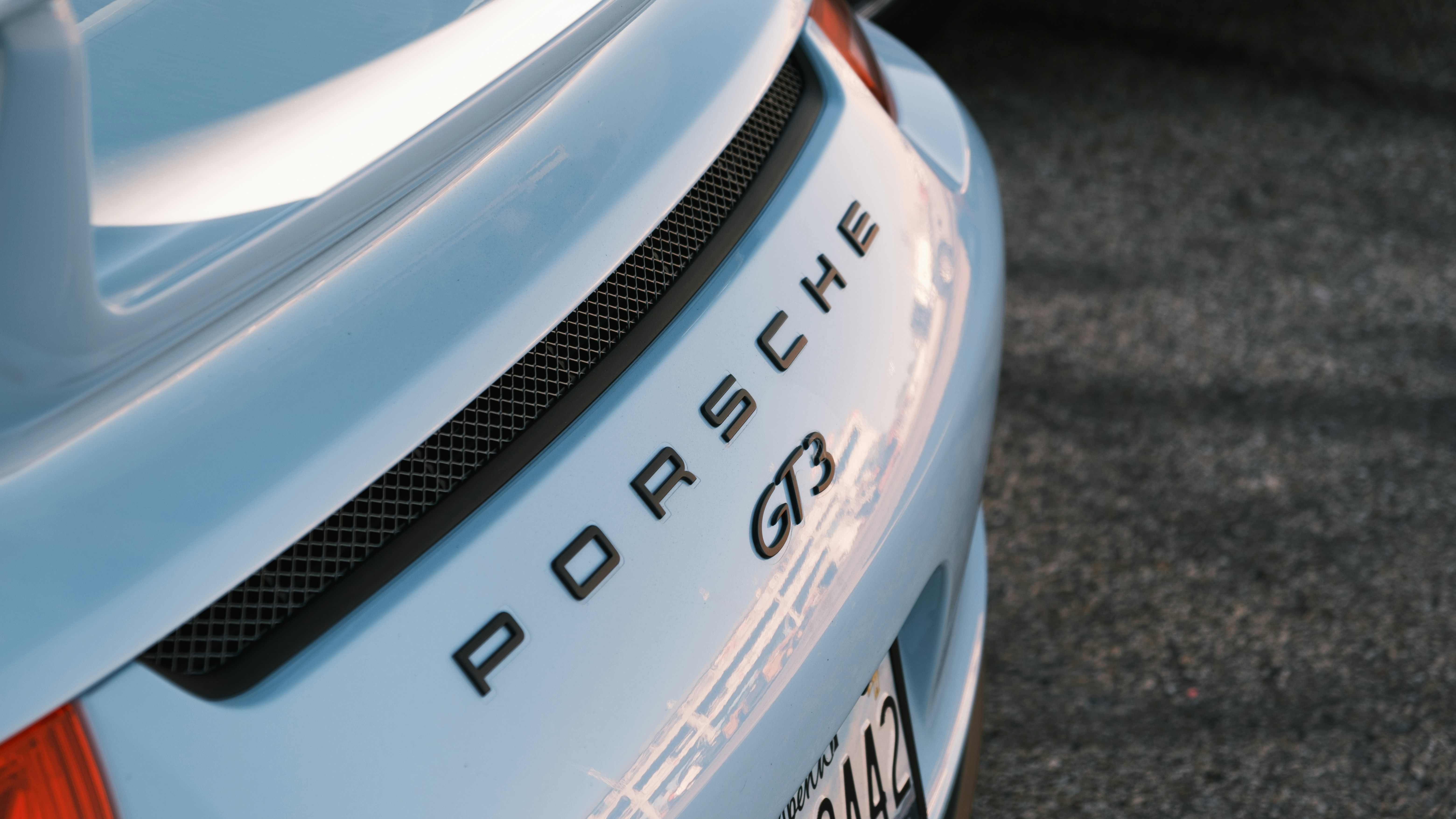 Polestar 2 electric fastback parked in front of modern architecture