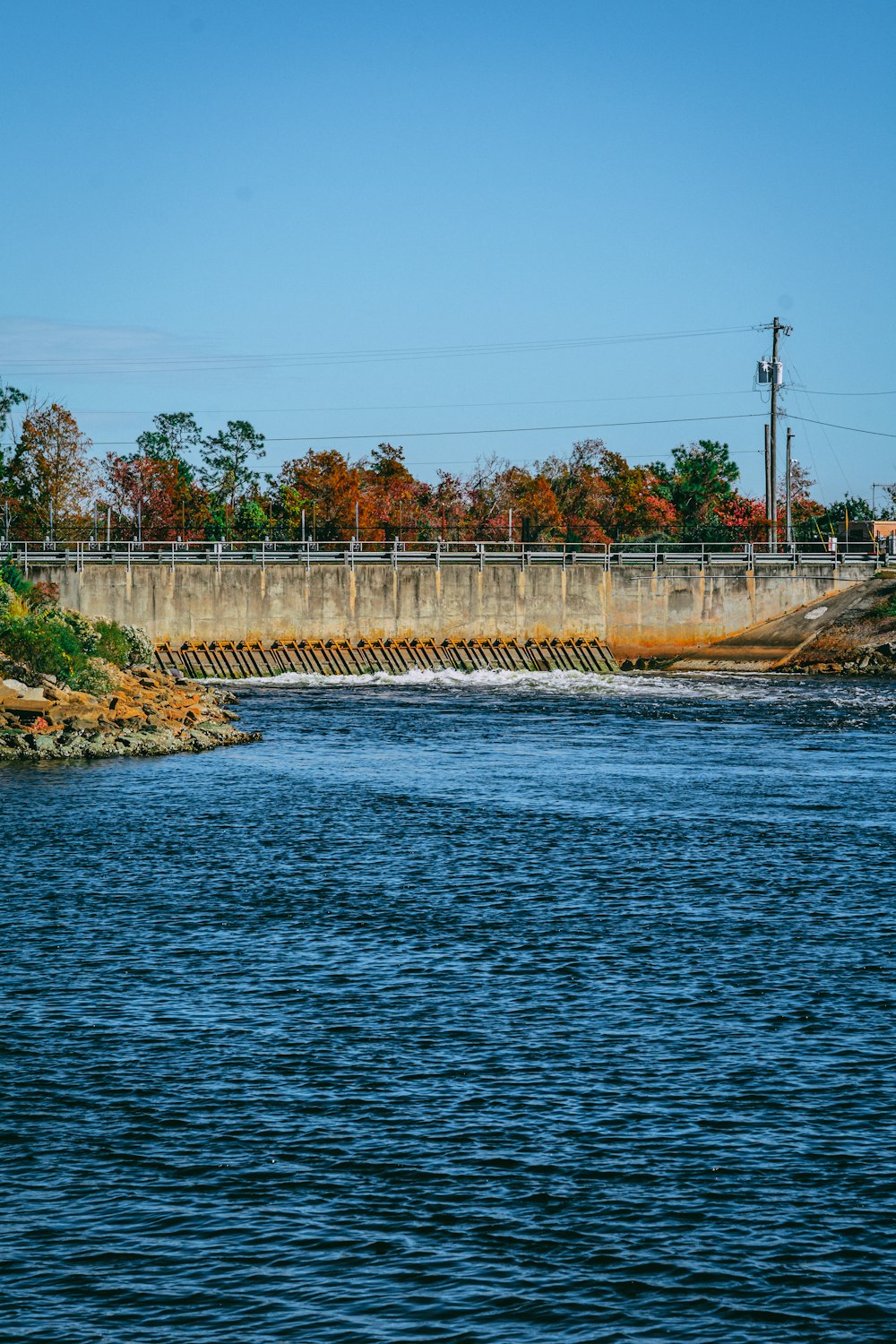 a large body of water with a bridge in the background