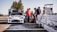 A group of people discussing safety measures at a motorsport event.