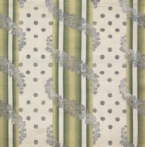 The image features a patterned textile design with alternating vertical green striped bands and beige dotted areas. The stripes have a textured, woven appearance, and floral motifs in grey overlay the stripes, creating a layered effect. The background has a soft, off-white hue, enhancing the contrast and detail of the patterns.