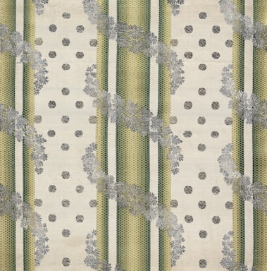 The image features a patterned textile design with alternating vertical green striped bands and beige dotted areas. The stripes have a textured, woven appearance, and floral motifs in grey overlay the stripes, creating a layered effect. The background has a soft, off-white hue, enhancing the contrast and detail of the patterns.