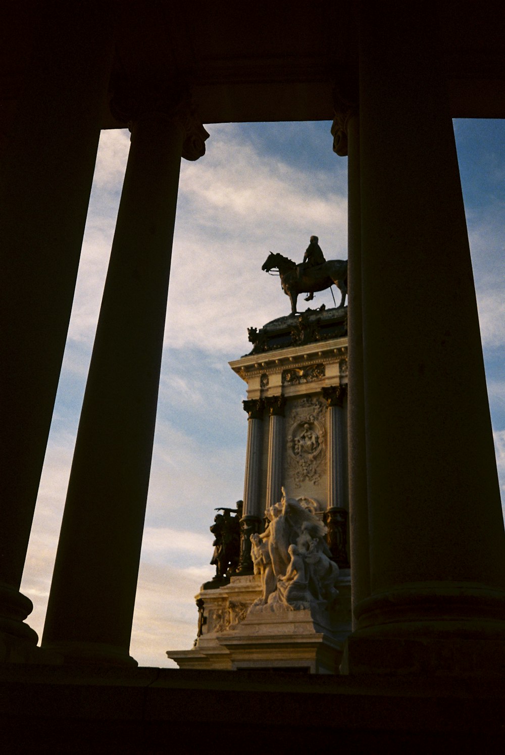 a statue of a man on a horse on top of a building