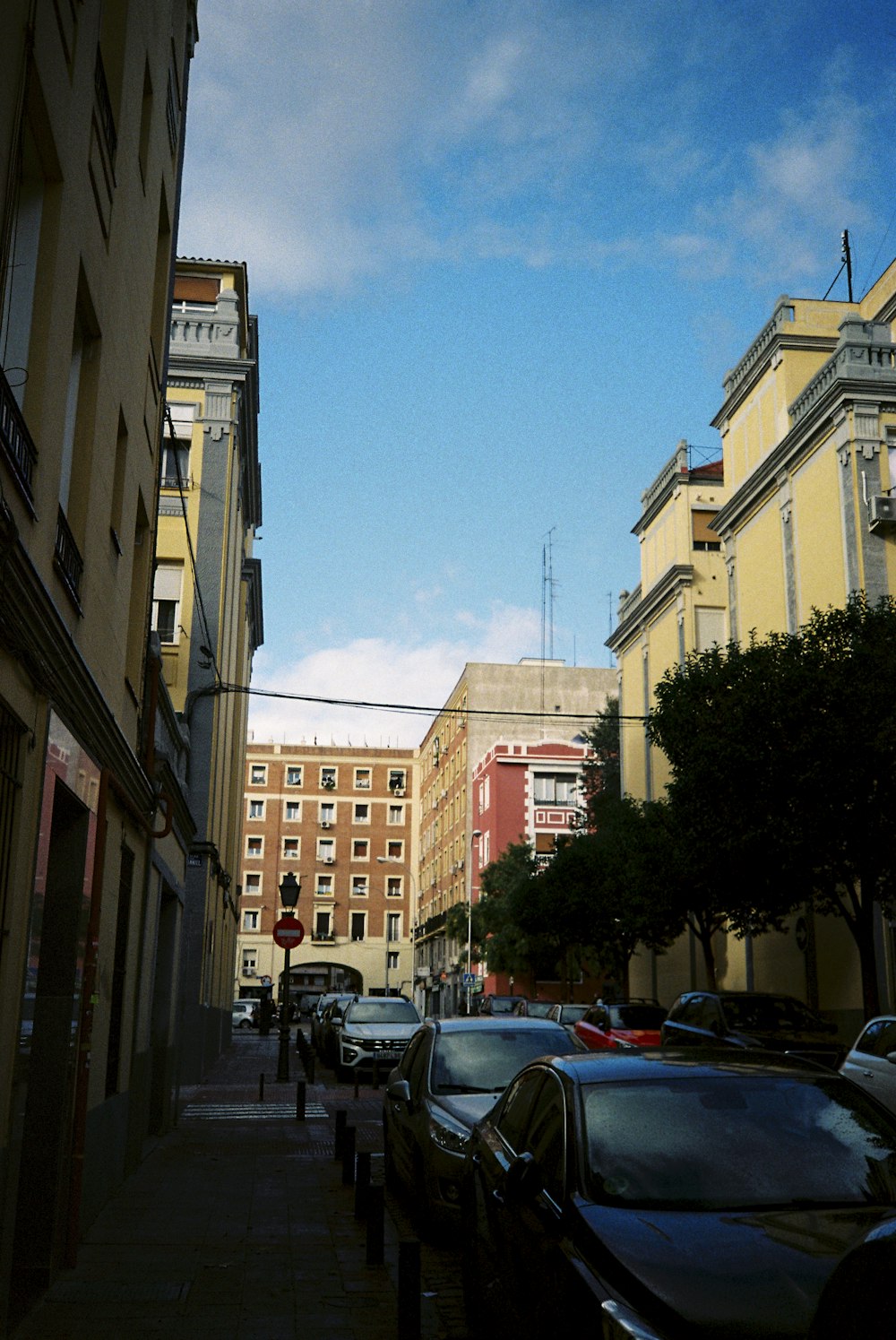 a row of parked cars on a city street