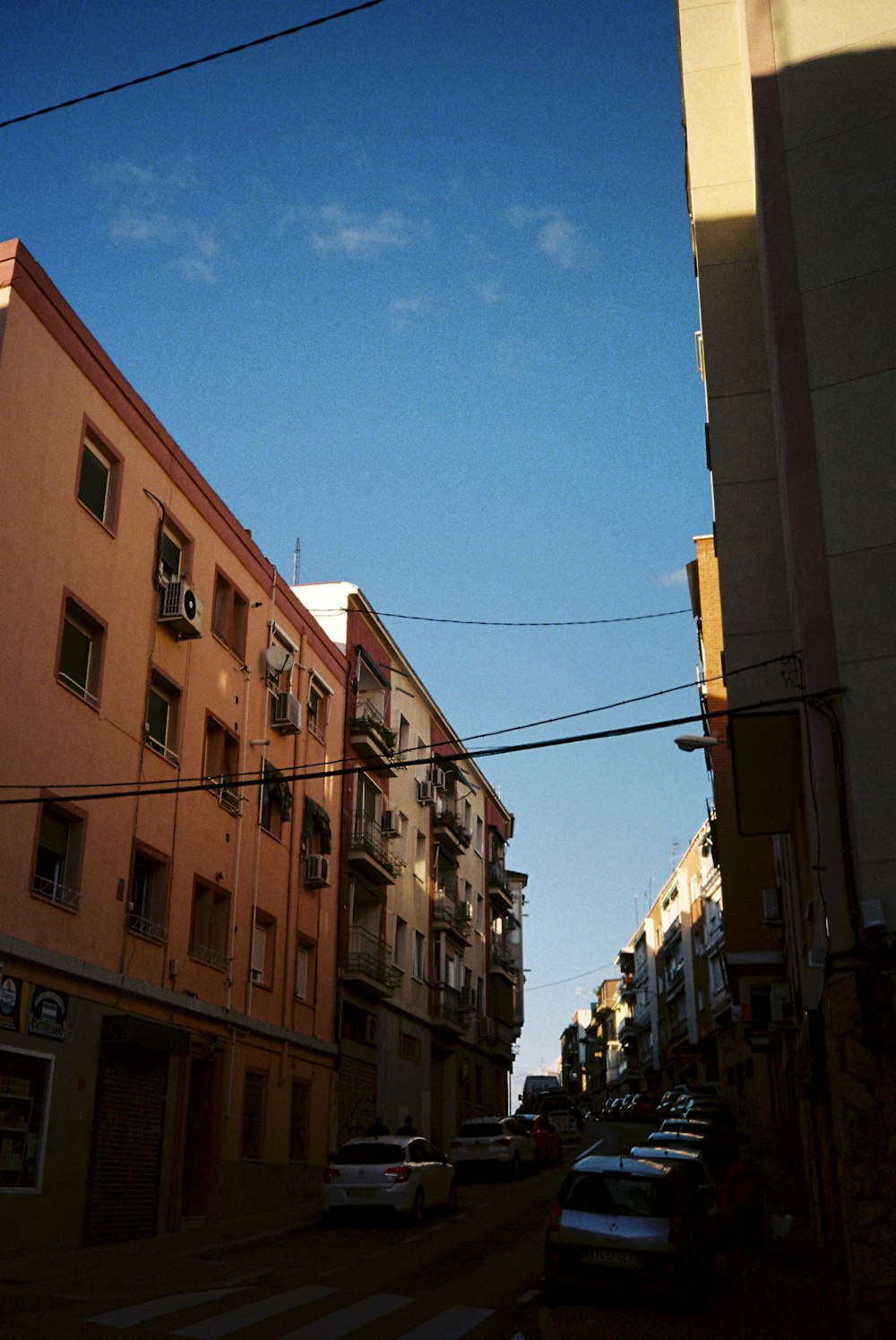 a city street with cars parked on the side of it