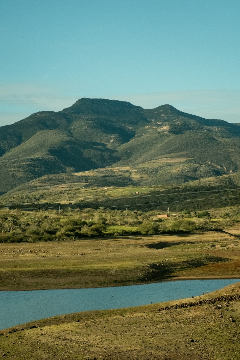 a mountain range with a body of water in the foreground