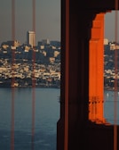 San Francisco’s iconic Bay Bridge framed by sleek office towers at dusk.