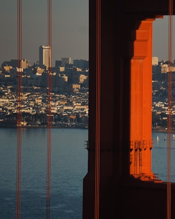 San Francisco’s iconic Bay Bridge framed by sleek office towers at dusk.