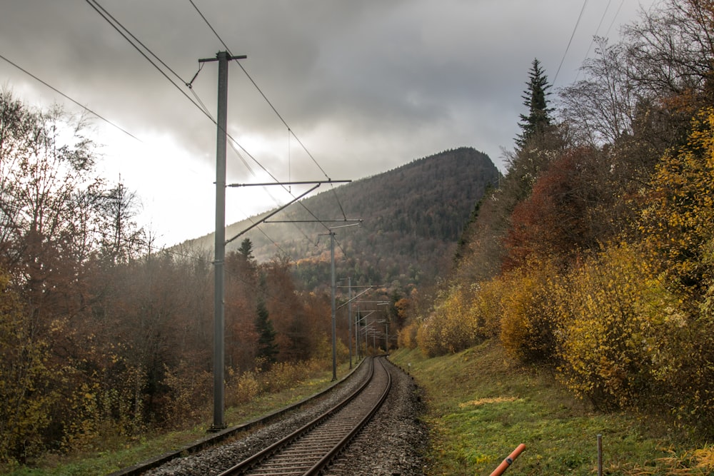 a train track with a mountain in the background