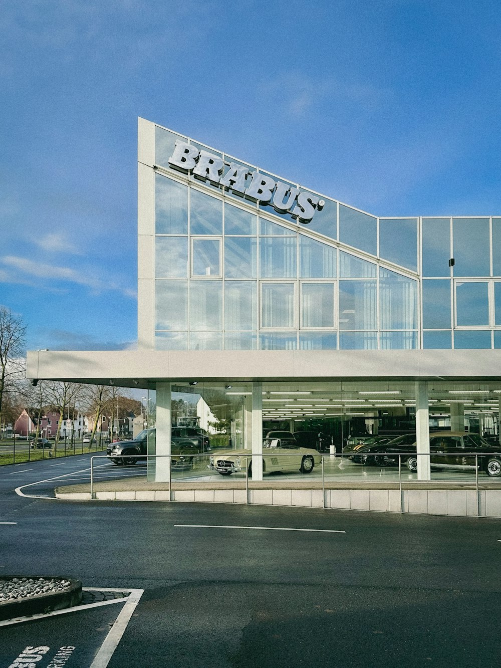 a car dealership with cars parked in front of it