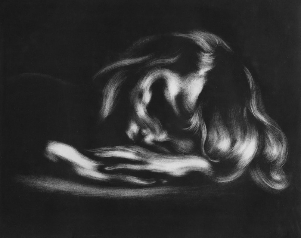 a black and white drawing of a woman's face