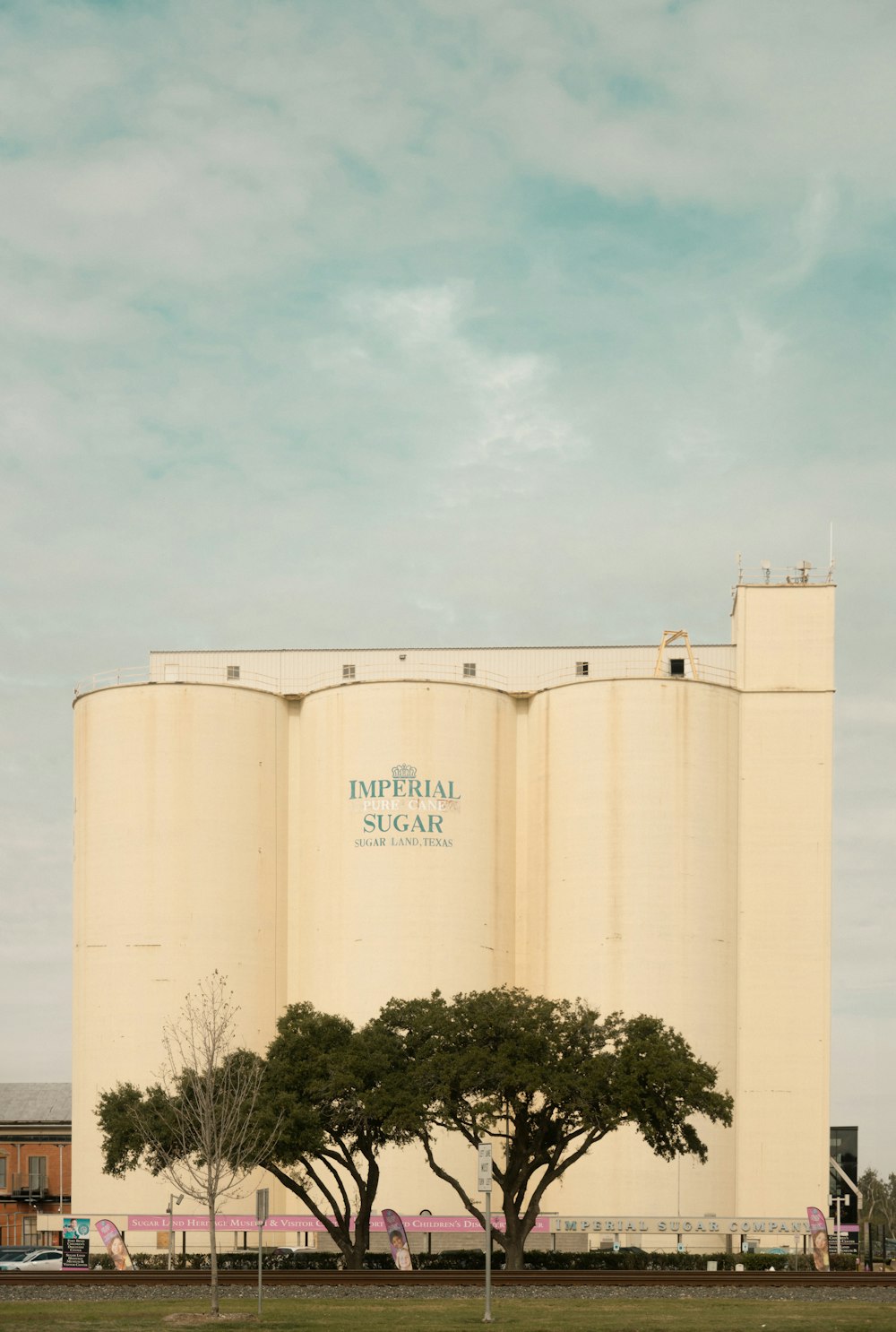a large grain silo sitting next to a tree
