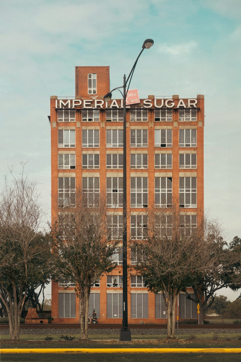 a tall brick building with a street light on top of it