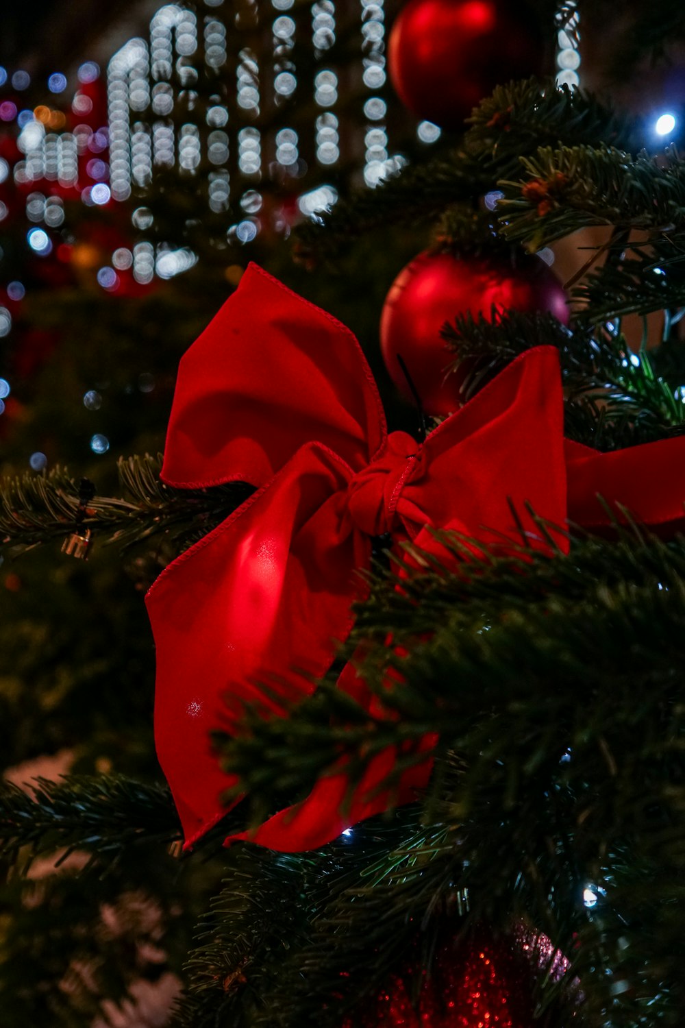 a close up of a christmas tree with a red bow