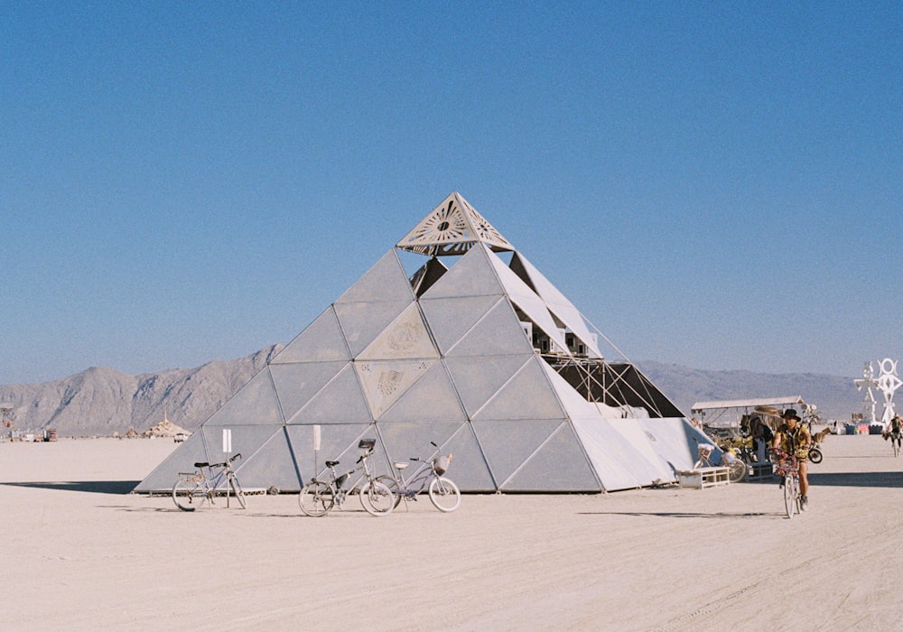 a pyramid shaped structure with bicycles parked in front of it