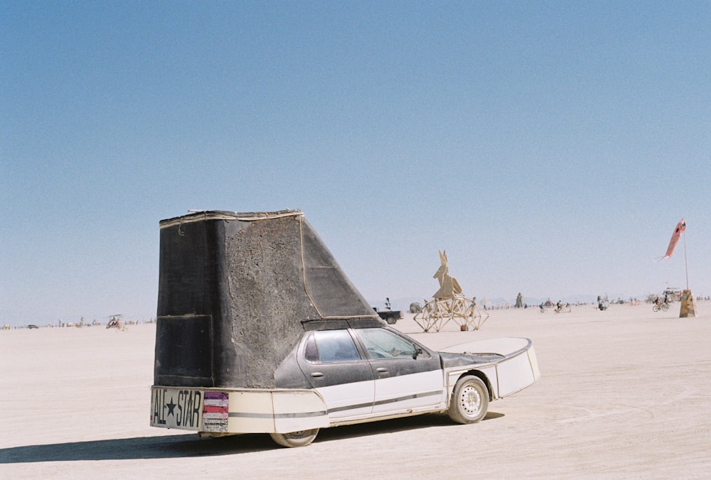 a car is parked in the middle of the desert