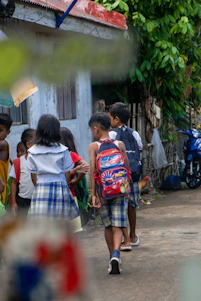 a group of children walking down a street