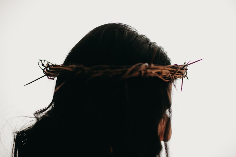 a woman with a crown of twigs on her head