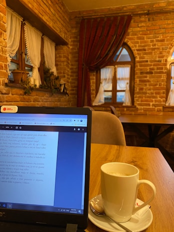 A cozy writing space with a laptop and coffee.