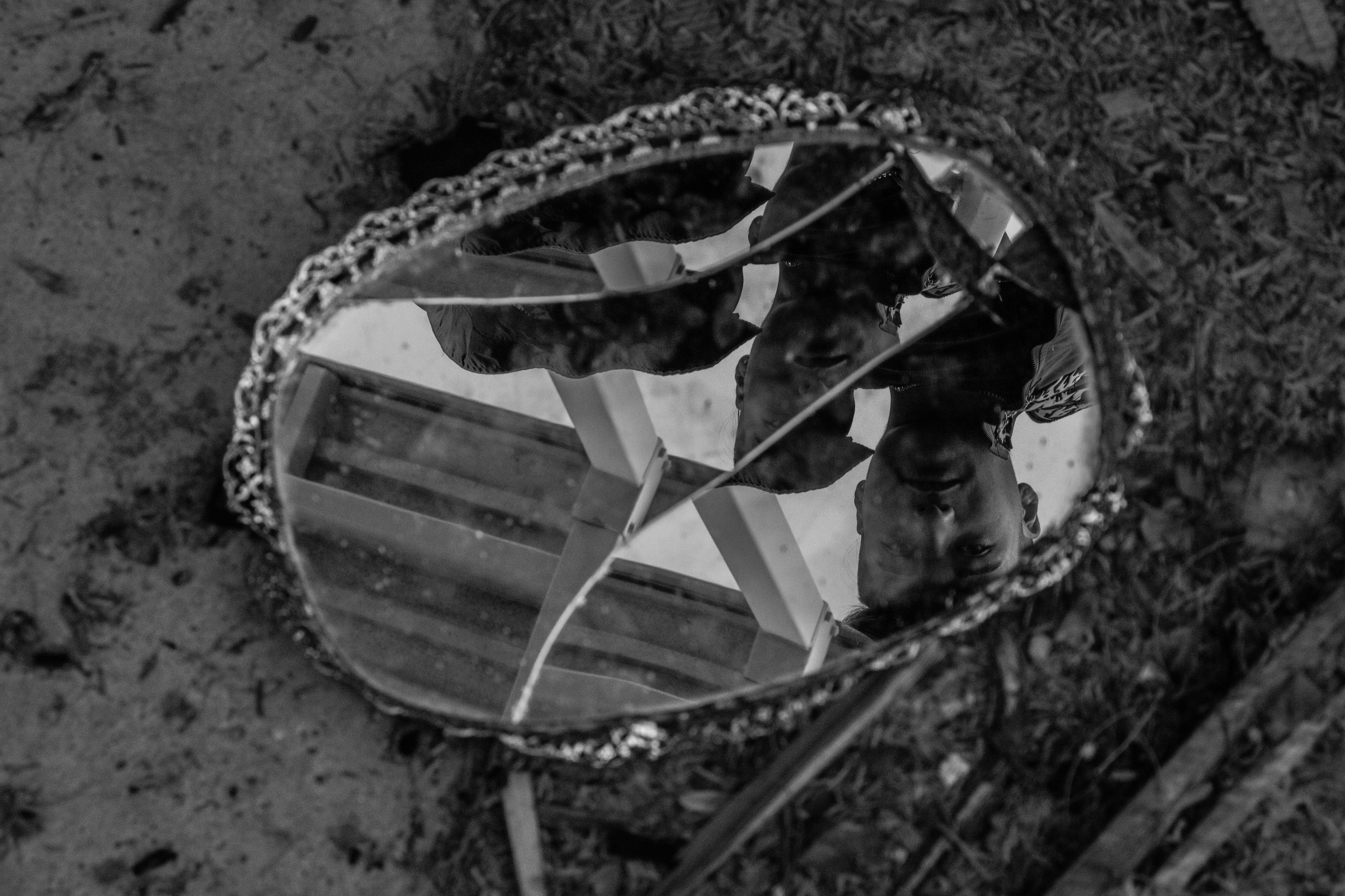 Shooting sad portraits with a male fashion model in sharp black and white, using a broken and shattered mirror reflection taking an edge on dark themes of grief, abuse, and mental health. Model Instagram @ant._.a