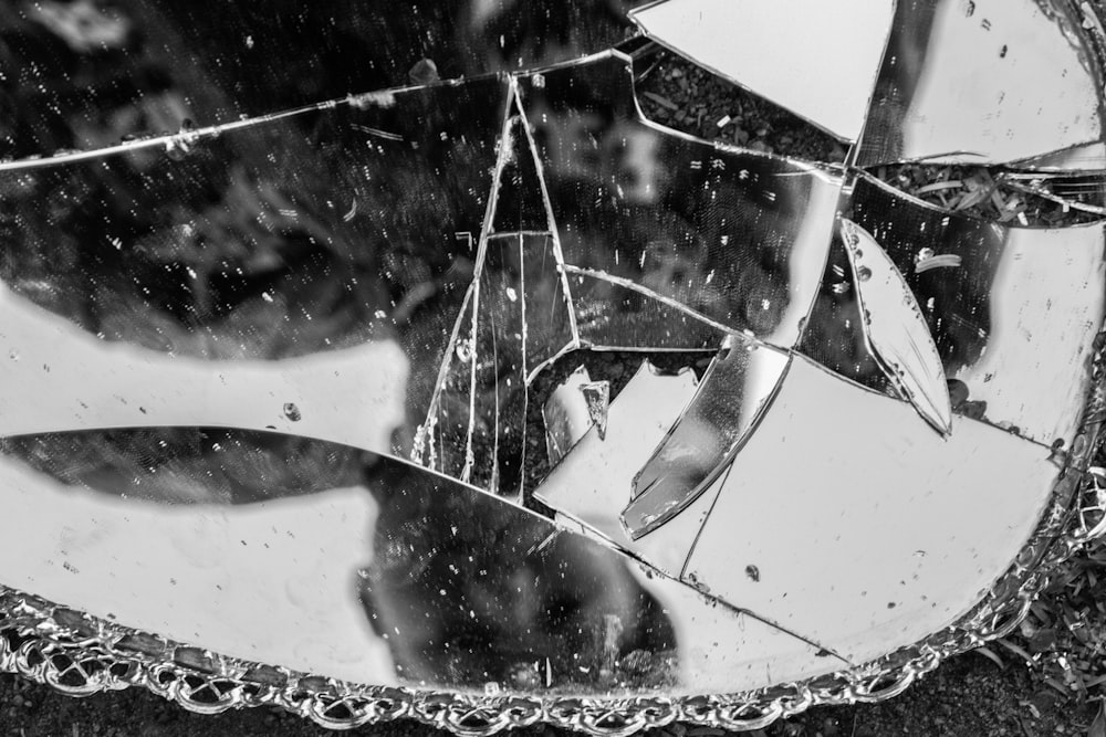 a broken mirror sitting on top of a sidewalk