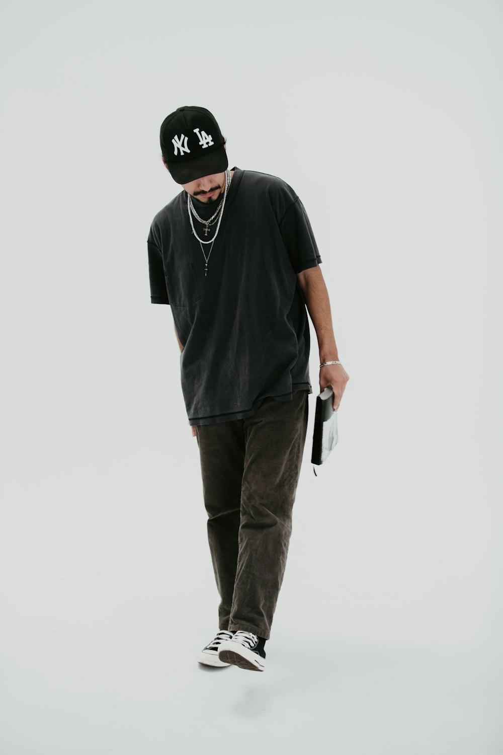 a man in a black hat and black t - shirt is skateboarding