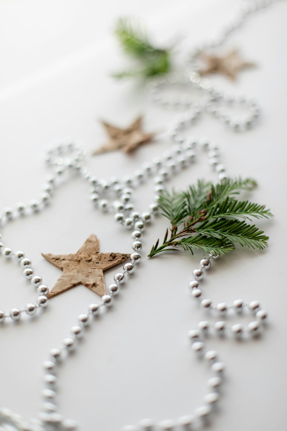 a white table topped with beads and christmas decorations