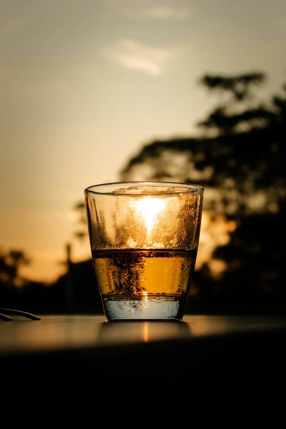 a glass of water sitting on top of a table