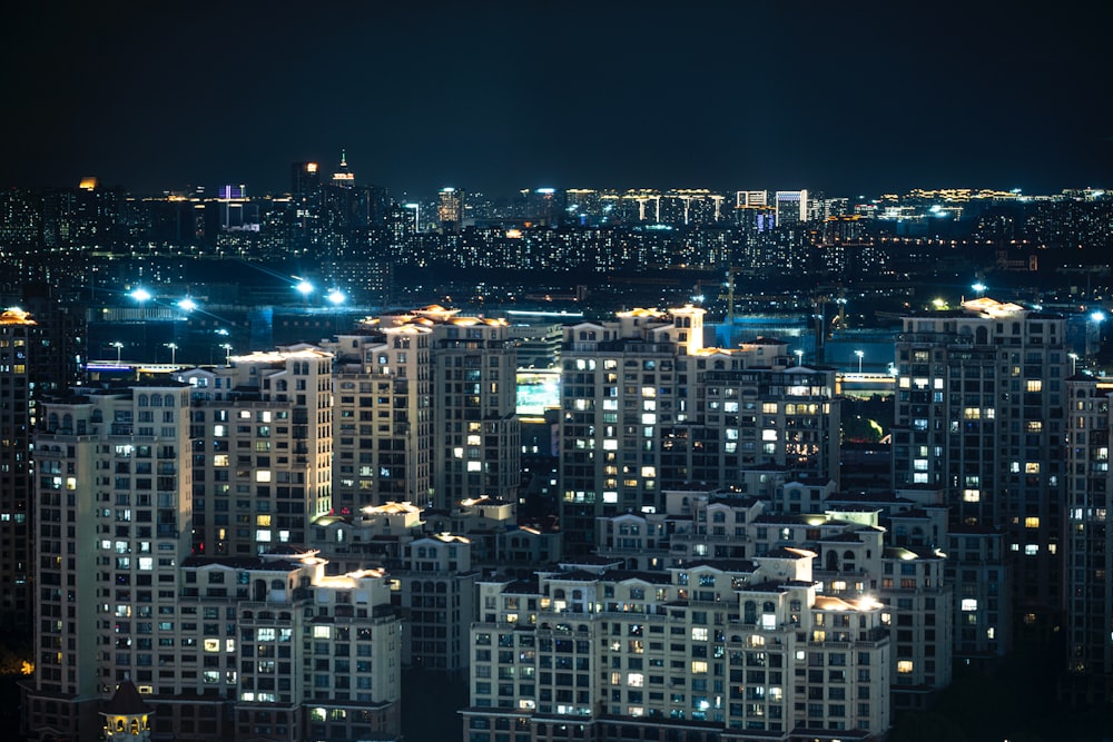 a city at night with lots of tall buildings