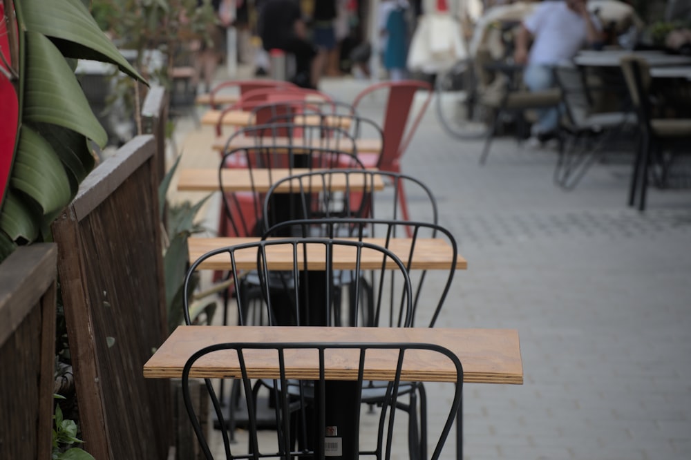 a row of wooden tables sitting on top of a sidewalk