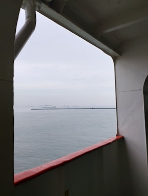 A friendly maritime office with a ship visible through the window.