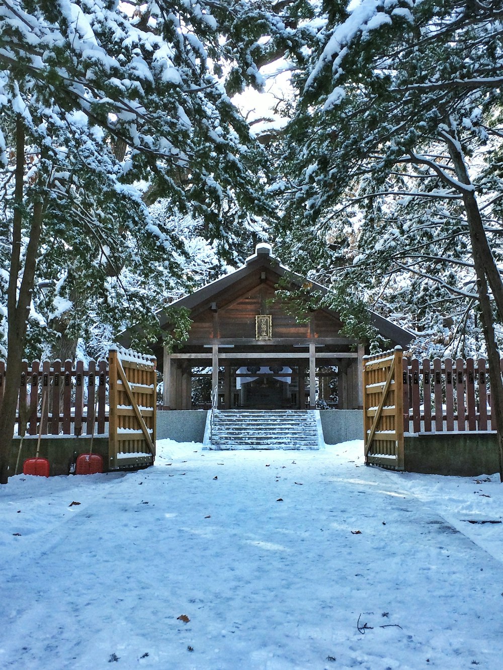 a small cabin in the middle of a snowy forest