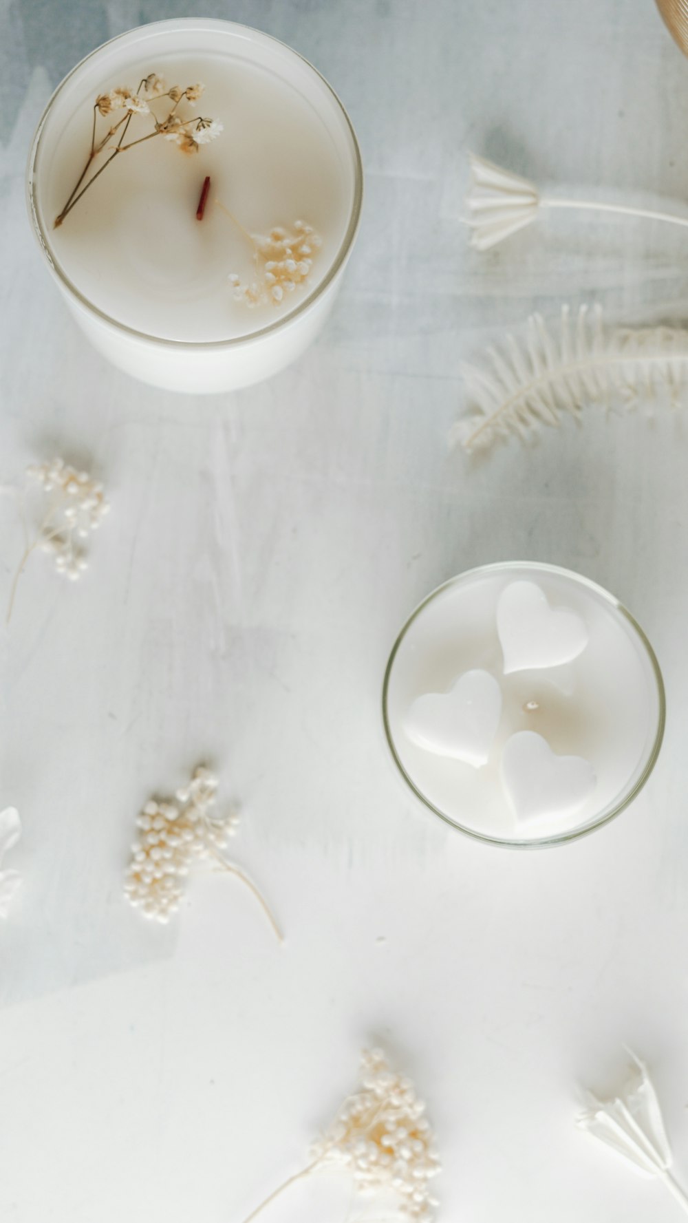 a white table topped with two glasses filled with liquid