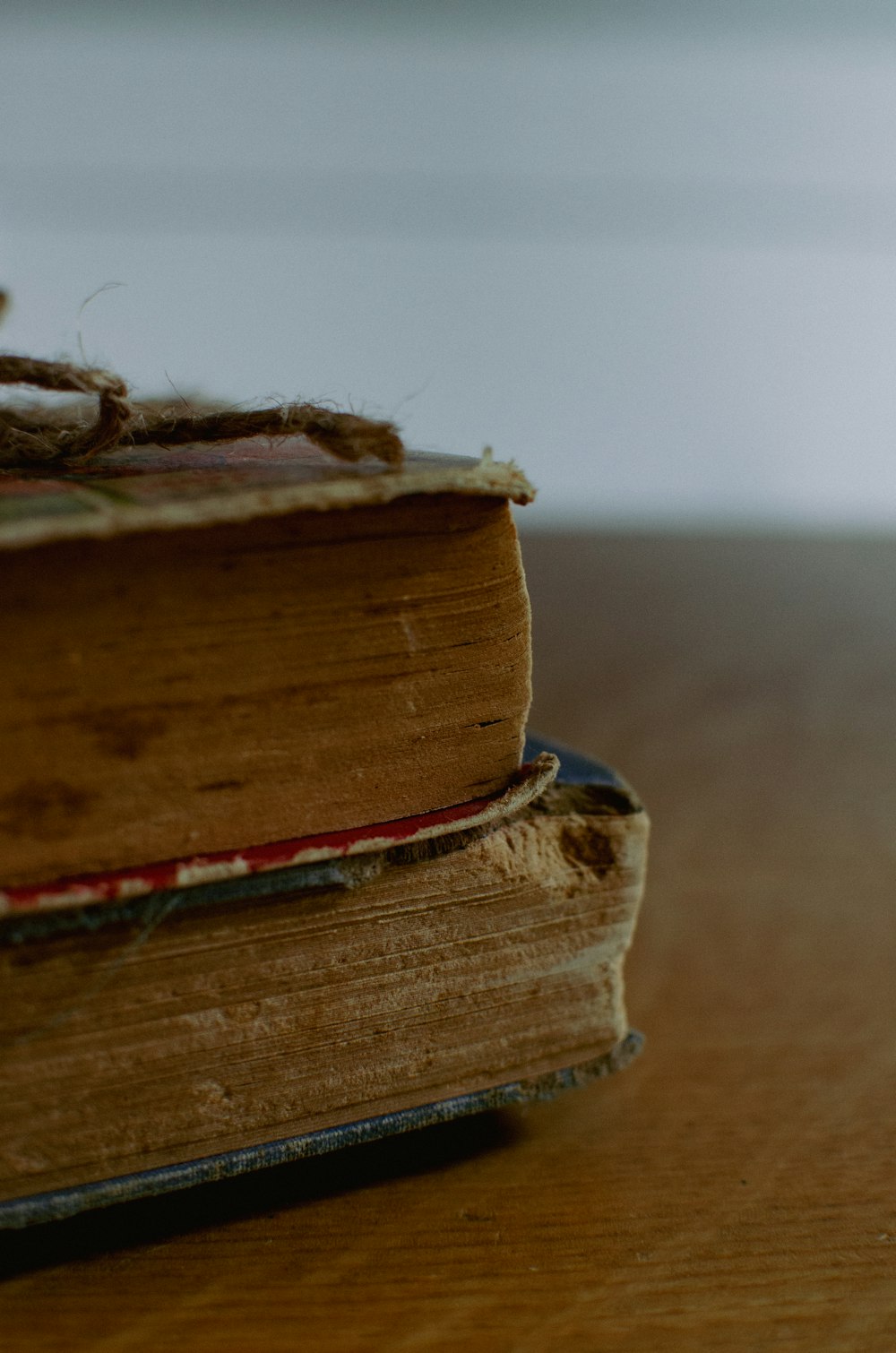 a stack of old books sitting on top of a wooden table