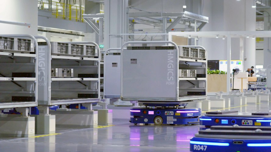 Rows of automated warehouse shelving units and robots inside a large fulfillment center
