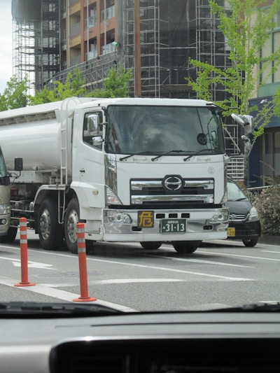 A large water tank truck parked in an urban area.
