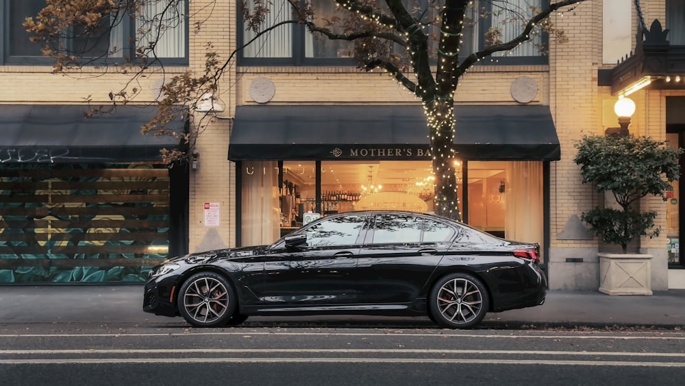 a black car parked on the side of a street