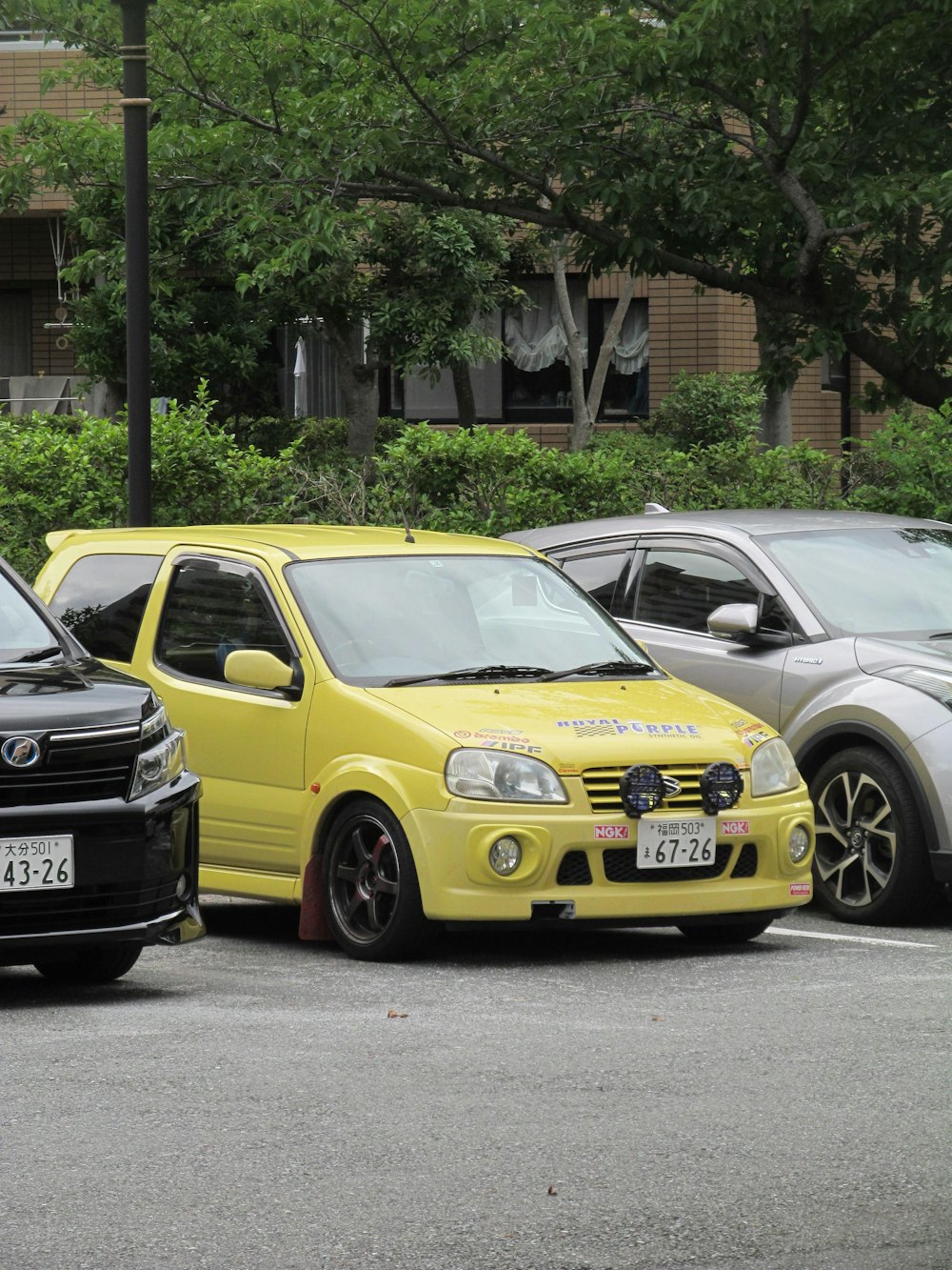 a couple of cars parked next to each other in a parking lot