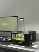 A minimalist desk setup with a small, elegant aquarium adding life and color.