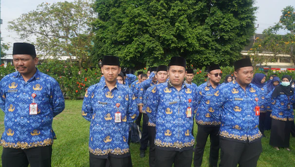 Group of employees wearing matching branded shirts at a corporate event.