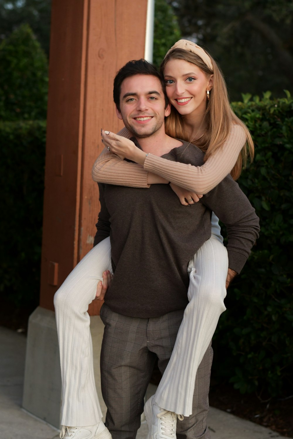 a man carrying a woman on his back