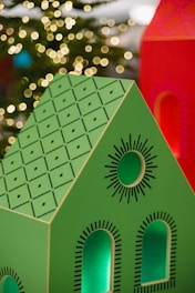 A stylish navy and gold themed energy certificate document next to a modern house model.