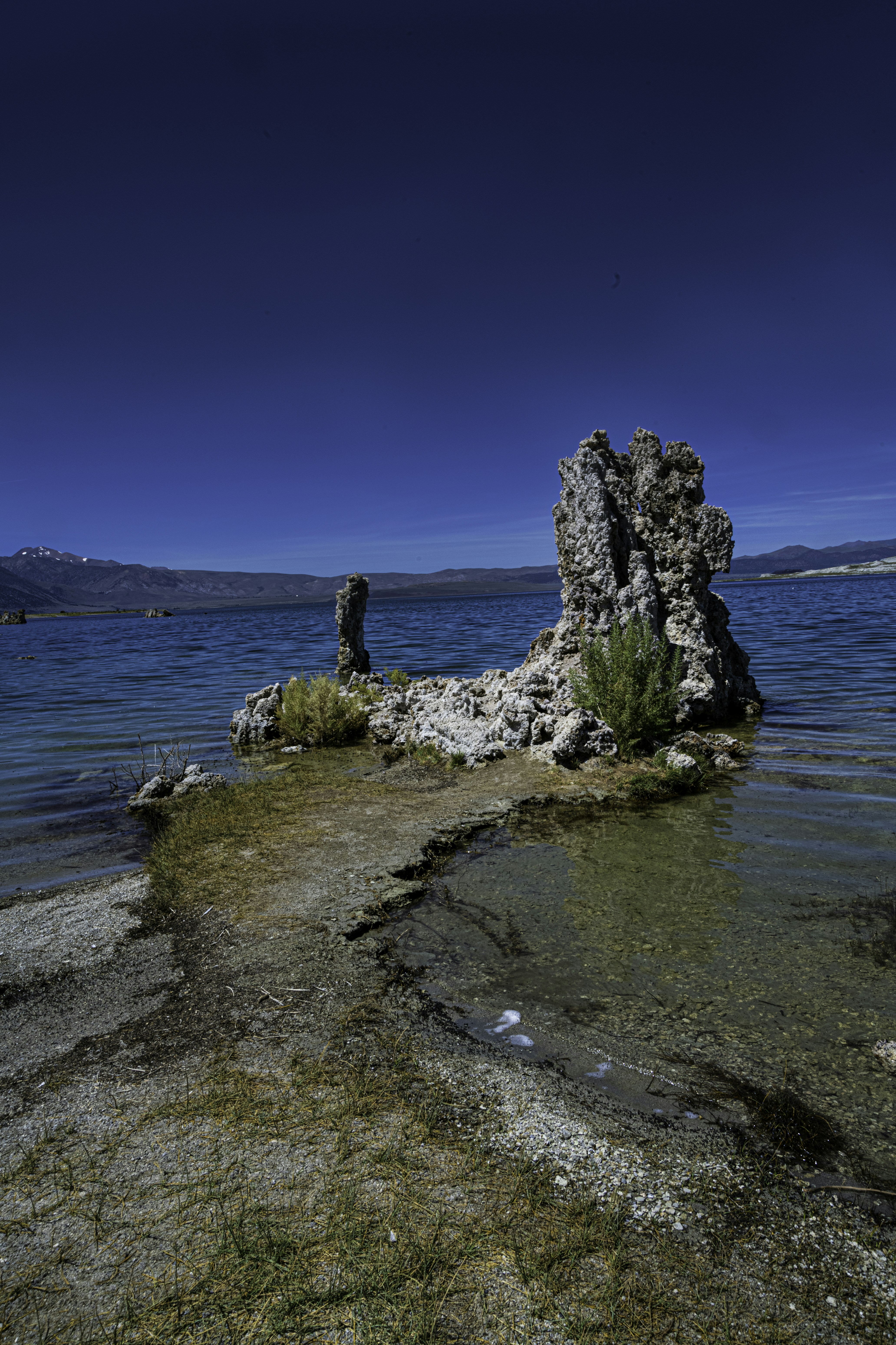 a rock outcropping in the middle of a body of water