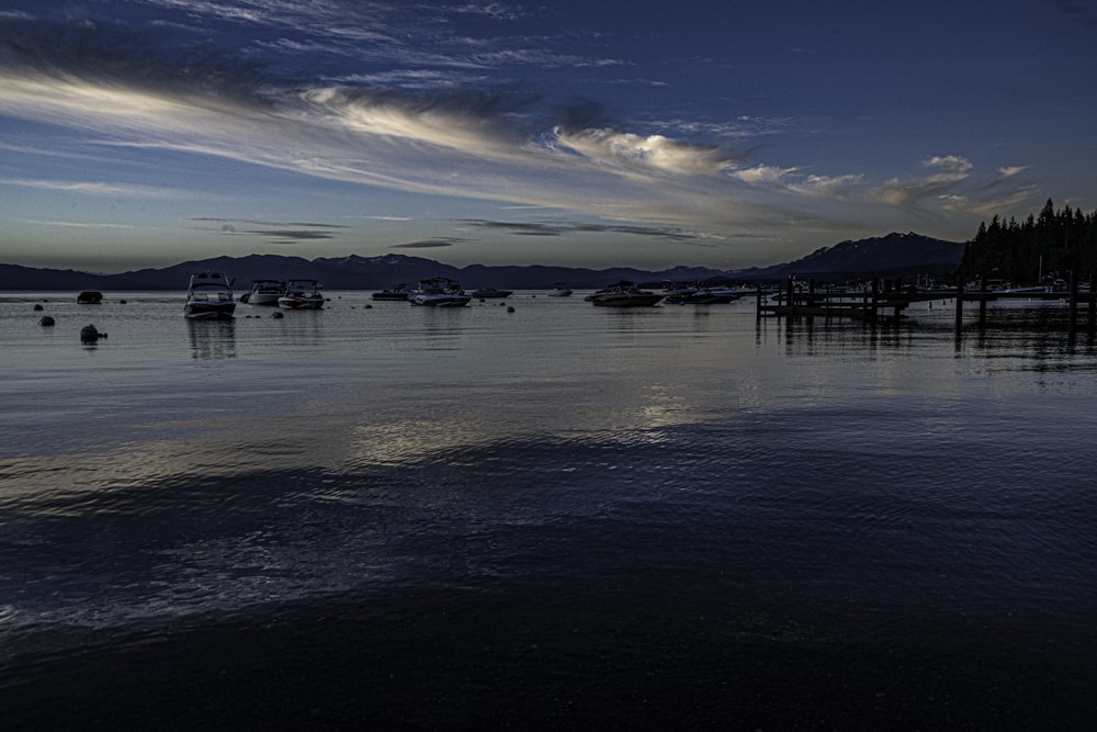 a group of boats floating on top of a body of water