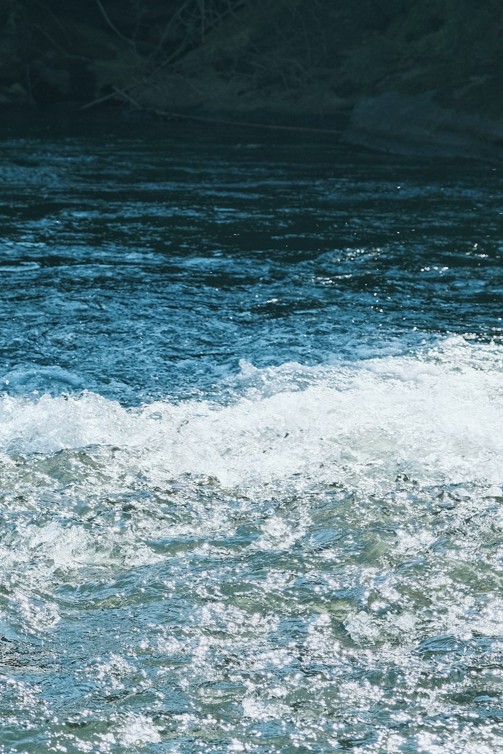 a man riding a wave on top of a surfboard