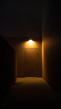 A dimly lit courthouse hallway lined with closed doors and scattered case files.