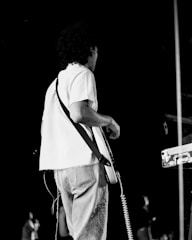 Photo of Roger Ricco performing live on stage with guitar.