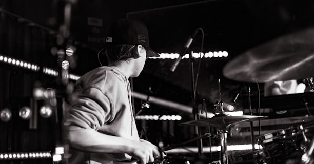 a man playing drums in a dark room