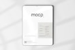 A digital mockup featuring a tablet with a minimalistic design. The screen displays a sleek interface with the word 'mocp' prominently at the top. Below it, there's information about features such as very realistic output and fully editable resolution. The background is clean and white, accented by soft shadows.